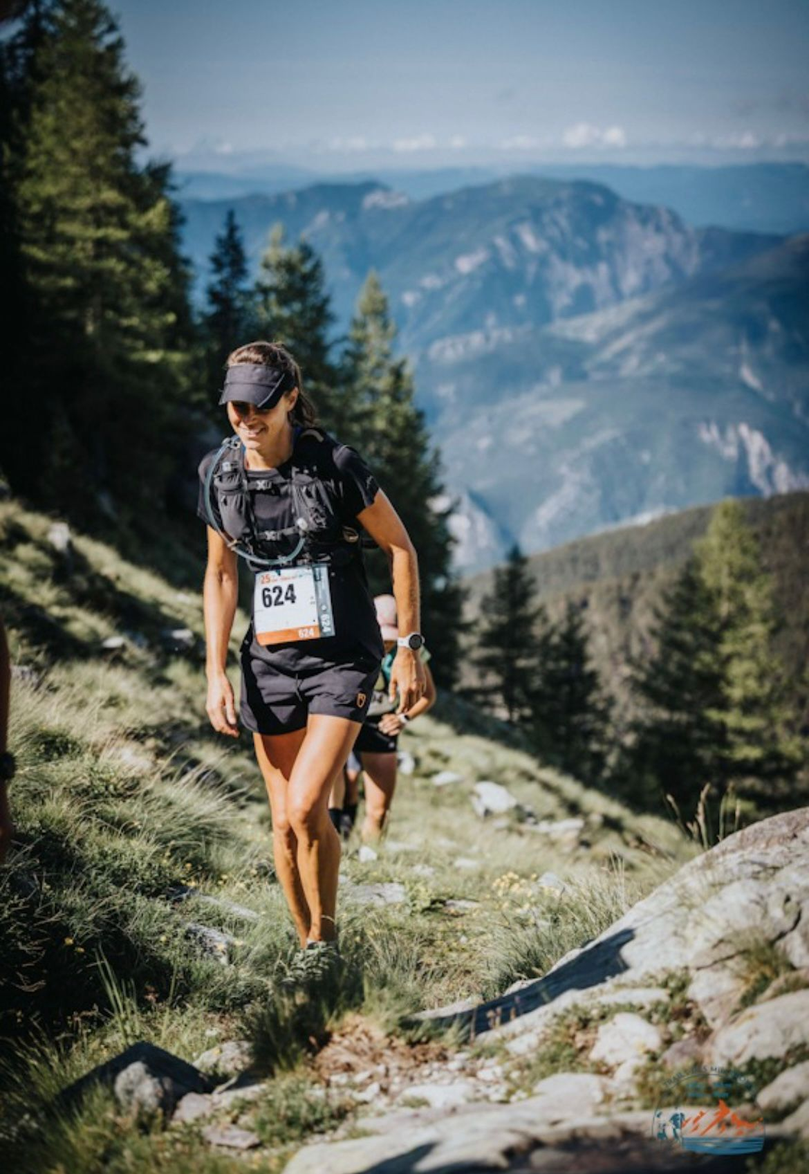 Cara running a forest trail race in running kit, mid-stride and focused.