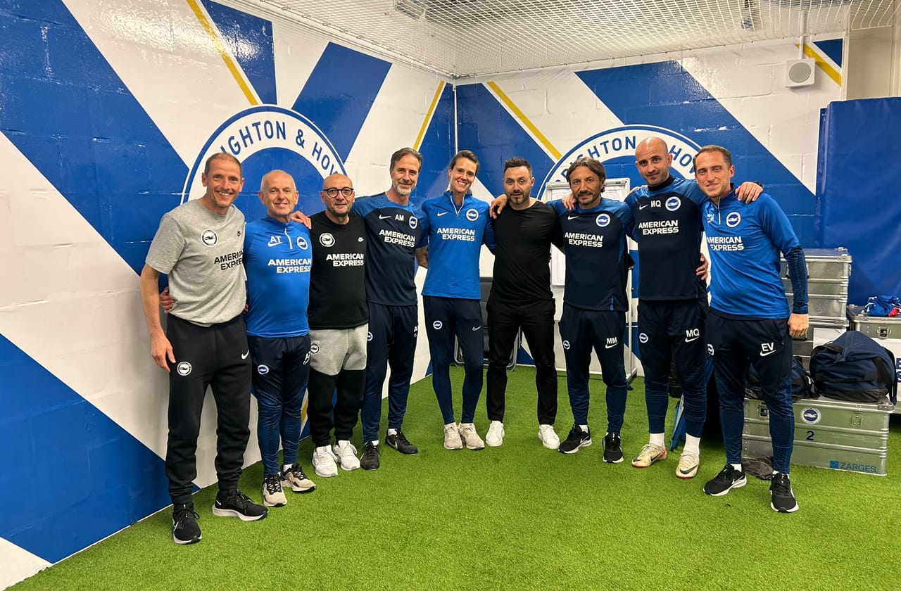 Cara Lea Moseley with the Brighton & Hove Albion first-team coaching staff in the training-ground tunnel.